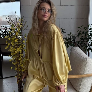 Yellow satin two-piece set with tie-front blouse and matching trousers in a relaxed fit