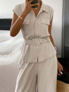 Detail of sleeveless striped two-piece set featuring waist belt and front pockets