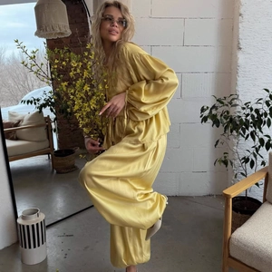 Elegant bright yellow satin two-piece set with puff sleeve blouse and wide leg trousers