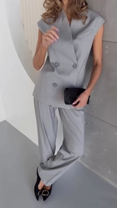 Detail of light gray double-breasted sleeveless blazer vest and matching wide-leg trousers