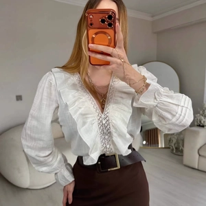 Elegant white V-neck blouse with ruffle sleeves and lace hollow out details in cotton
