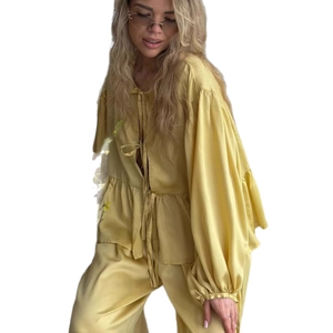 Elegant ginger yellow satin two-piece set with flared sleeve tie top and wide-leg trousers