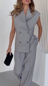 Detail of light gray double-breasted sleeveless vest and matching wide-leg pants