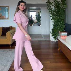 Pink two-piece set with short sleeve waist-tie blazer and high waist wide leg trousers