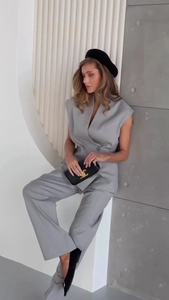 Detailed close-up of a double-breasted sleeveless vest and matching wide-leg trousers