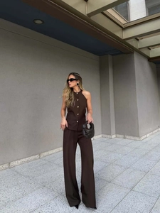 Detail of dark brown halter neck vest and high waist wide leg trousers two-piece set
