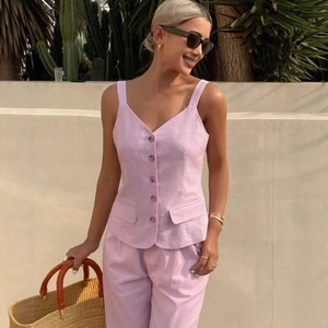 Chic pink linen-style two-piece set featuring sleeveless V-neck vest and matching trousers