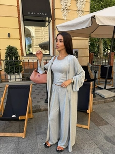 Detailed close-up of light gray three-piece set with cardigan, tank top and trousers