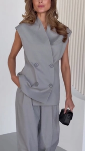 Detail of grey sleeveless double-breasted vest and matching wide-leg trousers suit