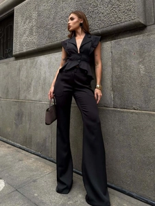 Detail of elegant black two-piece set featuring V-neck sleeveless top and wide-leg trousers
