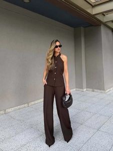 Brown two-piece halter vest and wide-leg trousers set shown in an outdoor street setting