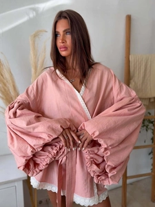 Detail of bohemian wrap blouse with lace trim embroidery and lantern sleeves