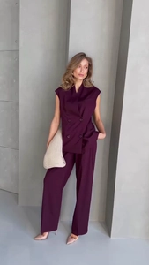 Full view of women's sleeveless double-breasted vest and matching trousers in dark plum
