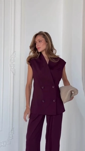 Detail of dark purple sleeveless double-breasted blazer vest with matching trousers