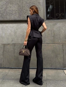 Back view of elegant black sleeveless peplum vest and high waist flare pants set