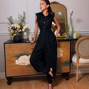Elegant black sleeveless buttoned blouse and matching trousers two-piece set for women