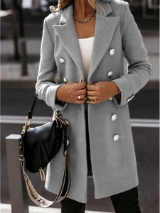 Detail of silver embossed buttons on a slim-fit double-breasted grey wool coat