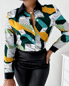 Detailed view of the colorful geometric print on the smooth satin fabric of this shirt