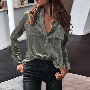 Detail of dark grey velvet shirt showing symmetrical flap pockets and collar texture