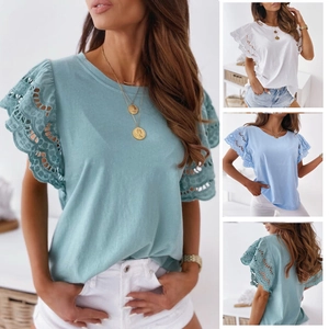 Close-up of eyelet lace embroidery on ruffled short sleeves of a summer V-neck top