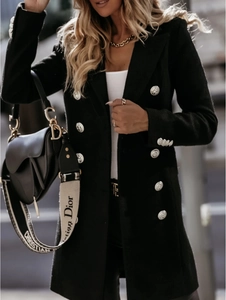 Detailed view of silver lion head embossed metal buttons on a black double-breasted coat