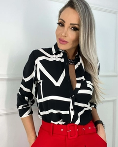Detail of lapel and monochrome geometric abstract pattern on long sleeve women shirt