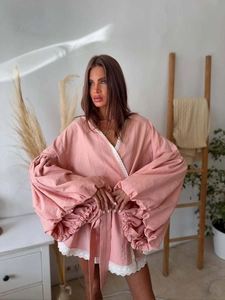 Detail of pink kimono robe featuring wide lantern sleeves and delicate white lace trim