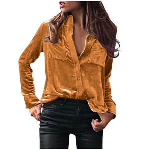 Detail view of glossy velvet fabric texture on a long-sleeve shirt with chest pockets