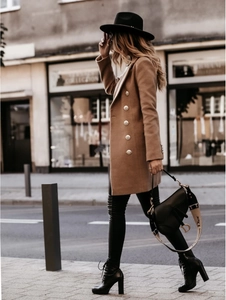 Detail of camel double-breasted coat with golden metal buttons and slim fit tailored cut