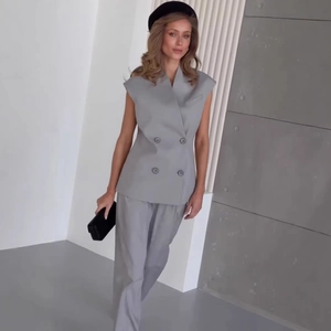 Women's chic grey double-breasted sleeveless vest and matching wide-leg trousers suit