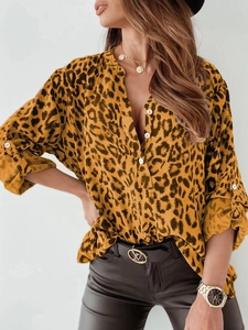 Detail of leopard print shirt featuring V-neckline, roll-up sleeves and button closure