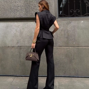 Elegant black peplum vest and high-waist trousers set for a professional women's look