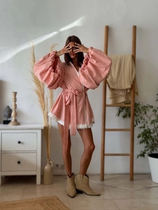 Detailed view of pink linen bohemian dress featuring lace trim and lantern sleeves