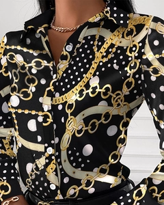 Close-up of women's vintage satin shirt with gold chain and white polka dot prints