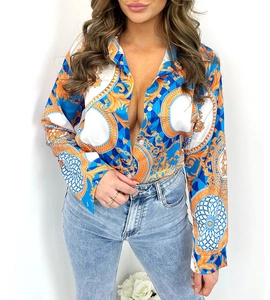 Close-up of long sleeve shirt with blue and orange baroque print and button-down collar