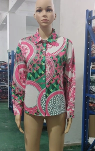 Detail of pink and green baroque print shirt with geometric patterns and white buttons