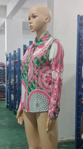 Detail of printed long sleeve shirt featuring green and pink baroque patterns with buttons