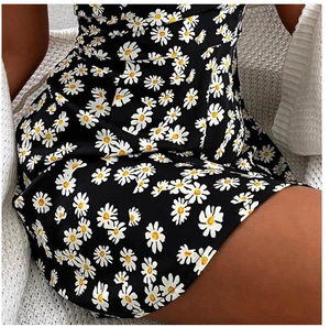 Detailed macro view of the daisy floral print on the black summer sleeveless dress