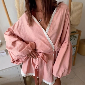 Pink lace trim lantern sleeve lace-up blouse featuring textured fabric and waist tie