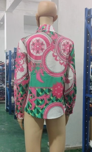Detailed back view of a baroque print shirt with green and pink floral patterns on a mannequin