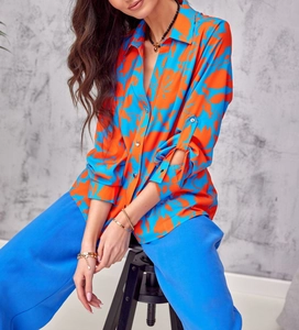 Detail of floral print shirt with blue and orange patterns on elegant chiffon fabric