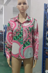 Close-up of vintage baroque print on long-sleeve shirt with buttoned cuffs and collar