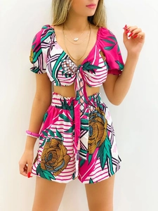 Detail of tropical floral print on a V-neck tie-front crop top and matching shorts set