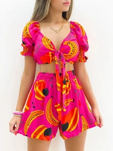 Detail of pink summer set with yellow banana print and V-neck tie front crop top