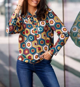Detail of elegant printed long sleeve blouse with geometric pattern and bow tie collar