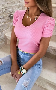 Close-up of pink ribbed knit texture with elegant V-neck and puffed sleeve details