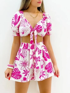Detail of pink floral tropical print V-neck tie-front top and high waist shorts set
