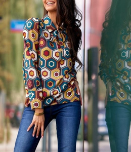 Detail of pussy-bow neck and geometric print on a long-sleeve elegant women's blouse