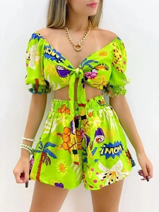 Close-up of neon green tropical print set with tie-up top and high waist shorts