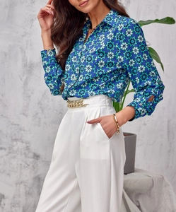 Detail of vintage geometric floral print shirt paired with white wide-leg trousers